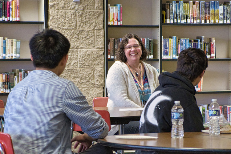 Kate Weller, MD, smiling during her "Pizza with a Pro" lunch presentation at Port Angeles High School